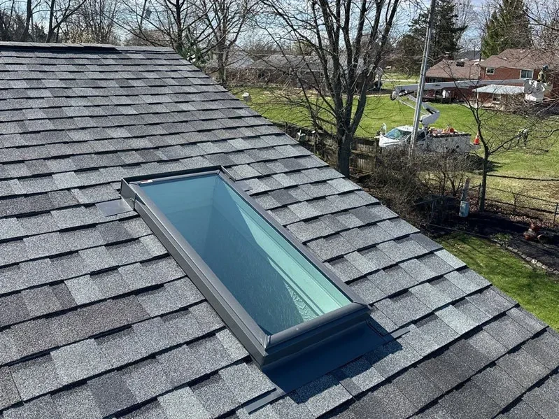 image of a skylight on a shingle roof