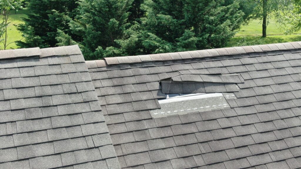 Image of shingles blown away by strong wind